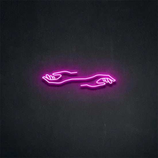 Purple neon sign of two hands with plexiglass mount on a dark wall mani neon