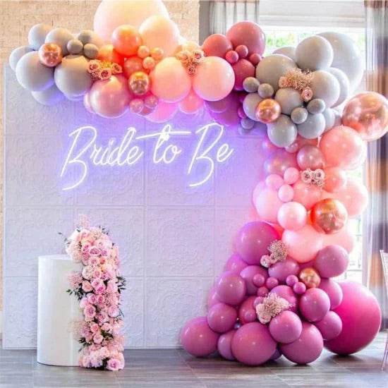 Bride to be neon sign with pink and gray balloon arch decoration for bridal shower