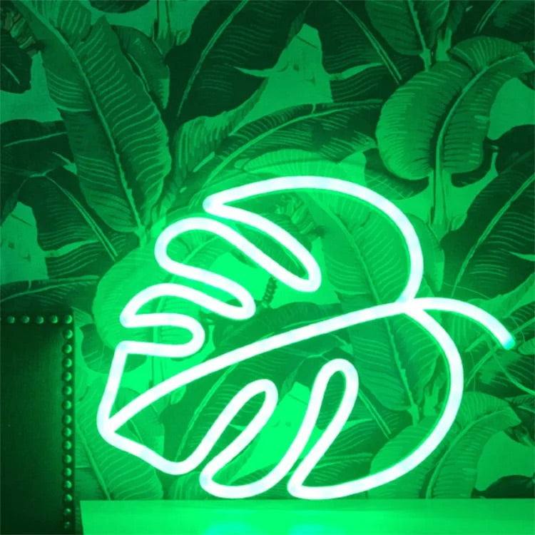 Foglia al neon glowing green neon leaf light on wall with tropical leaf background