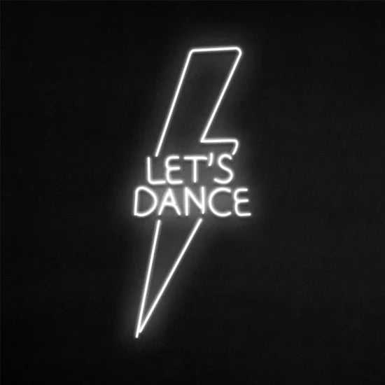 Let's dance neon sign in white lightning bolt shape on black background