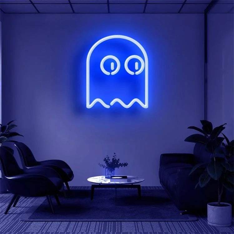 Blue neon Pac Man ghost sign on wall in modern lounge room