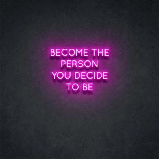 Pink neon sign reading "Become the person you decide to be" on a dark wall
