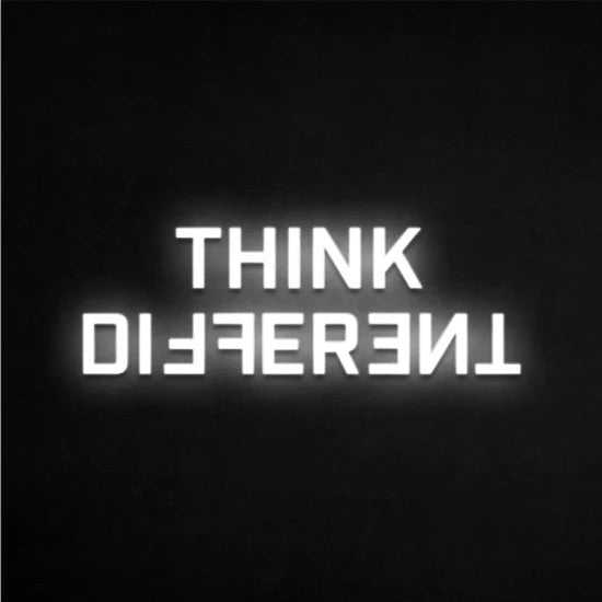 Think different neon sign with white glowing letters on black background