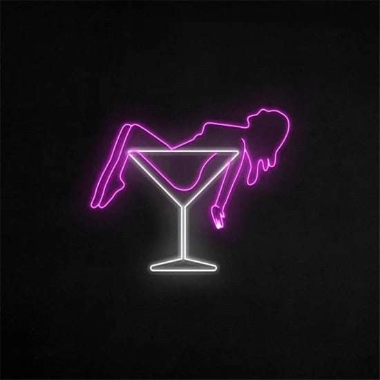 Donna drink neon sign with pink woman silhouette lying in white martini glass on black background